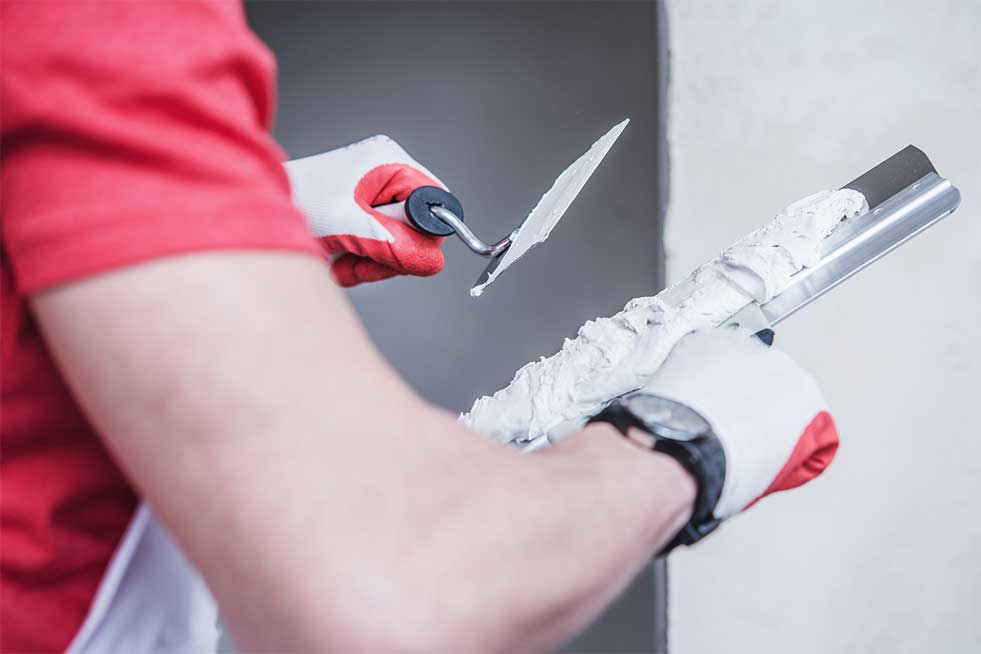 painter leveling the walls